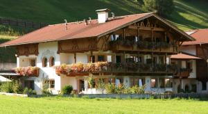 a large house with flower boxes on the front of it at Pension Margretenhof in Fulpmes