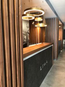 a bar in a restaurant with wooden walls and lights at Hotel Lima - Adults Recommended in Marbella