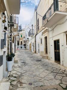 an empty street in an alley with buildings at Civico 27 in Ostuni +26 photos