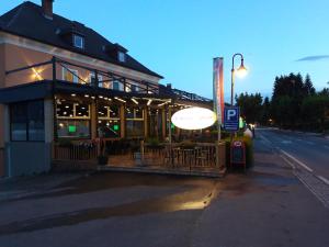 a building with a restaurant on the side of a street at Santa Lucia Apartments in Bodensdorf +18 photos