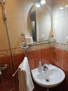 a bathroom with a sink and a mirror at Studio apartman Zana in Gradac