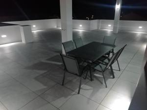a black table and chairs on a white floor at Skockica in Dugi Rat