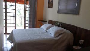 Cama ou camas em um quarto em Sítio Flora Rei