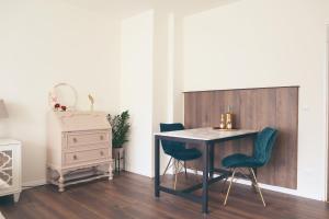 a dining room with a table and chairs and a dresser at GATSBY Apartment in Gelsenkirchen