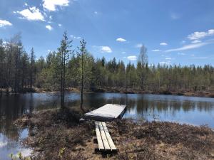 a dock in the middle of a lake at Villa Kelotupa in Hossa