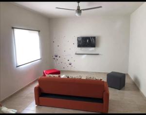 a living room with a couch and a window at Terra Viva Villa Campestre in Cuatrociénegas de Carranza