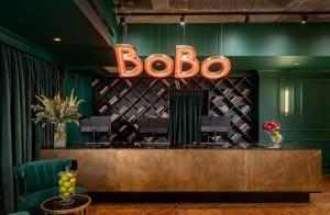 a bar with a sign that readsboo at Brown BoBo, a member of Brown Hotels in Tel Aviv