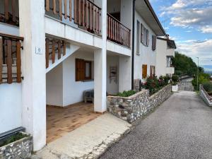 a large white building with wooden floors and balconies at Da Mercedes in Cornino