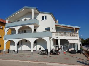 two motorcycles parked in front of a building at Apartman Luka in Vodice