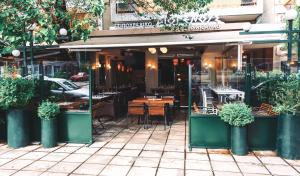 a restaurant with a table and chairs outside of it at Beautiful Apartment -up to 4 guests- close to City Centre! in Thessaloniki