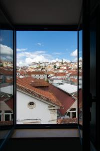 a view of a city from a window at Hotel Vitória in Coimbra