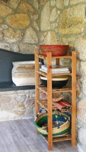 a wooden shelf with plates and bowls on top at Casa Colmeia in Esposende +33 photos