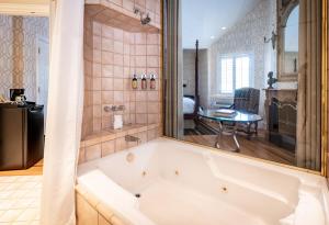 a white bath tub in a bathroom with a table at The Bergson in Calistoga