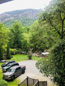 a couple of cars parked in a parking lot at The Evening Shade River Lodge and Cabins in Chimney Rock