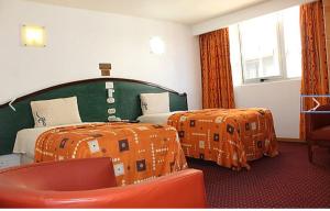 Postel nebo postele na pokoji v ubytování Hotel California