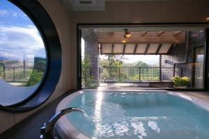 a swimming pool with a large window in a house at Riverte Kyoto Kamogawa in Kyoto