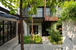 an external view of a building with a balcony at Cherlock hotel in Chiang Mai