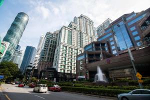 a busy city street with cars and buildings at 163 KLCC by Plush in Kuala Lumpur