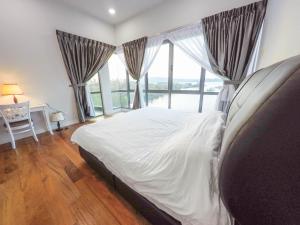 a bedroom with a bed and a large window at Luxury Condominium at Loft Imago in Kota Kinabalu