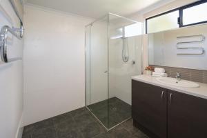 a bathroom with a shower and a sink at Redgate Forest Retreat in Witchcliffe