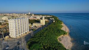 an aerial view of a building next to the ocean at Daily & Weekly Condominium BLUE OCEAN ISHIGAKI in Ishigaki Island