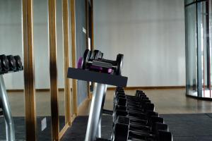 a camera on a stand in a room with chairs at Timur Bay Seafront Residence by DamaiFresh in Kuantan