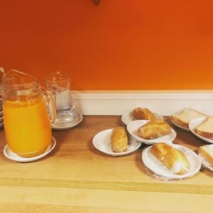 a table with plates of food and a pitcher of orange juice at Hotel Maruja Nozana in Viella