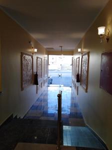 a hallway with paintings on the walls of a building at بريق الماس in Taif