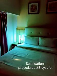 a bedroom with a large bed with blue lighting at BIG M Hotel in Kuala Lumpur