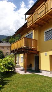 a house with a deck on the side of it at Apartmaji Zupan in Bohinjska Bela