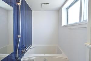 a bathroom with a shower and a sink at Daily & Weekly Condominium BLUE OCEAN ISHIGAKI in Ishigaki Island