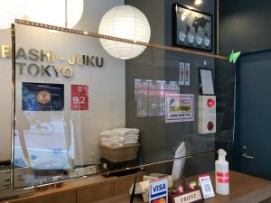 a store window with a mirror and lights on it at Tokyo Guest House Itabashi-juku in Tokyo