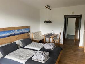 a bedroom with a bed and a table in it at Apartment Sandra in Bad Goisern