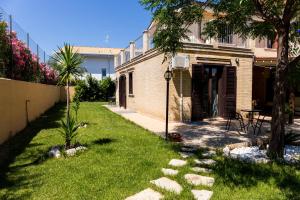 a backyard with a lawn with rocks in the grass at Villa Saraceni in Vasto