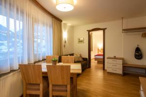 a living room with a table and a couch at Haus Monika in Bartholomäberg
