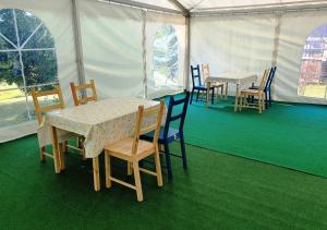 a dining tent with tables and chairs in it at Green Eden in Gornji Zvečaj +23 photos