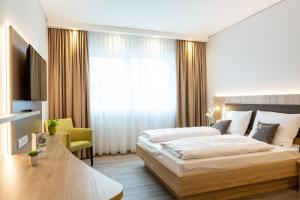 Postel nebo postele na pokoji v ubytování Aparthotel Am Pfaffenstein