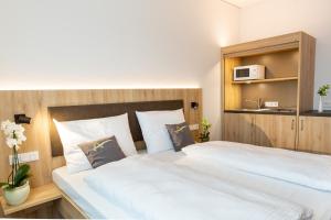 Postel nebo postele na pokoji v ubytování Aparthotel Am Pfaffenstein
