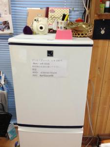 a white refrigerator with a camera on top of it at Goto Guest House Utojuku in Goto