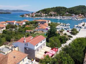 a town with a marina and boats in the water at Slanac in Veli Iž