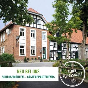 un edificio con una señal delante de él en Almer Schlossmühle en Brilon