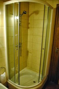 a shower with a glass door in a bathroom at Casas Da Faja in Praia do Norte