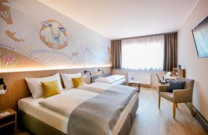 Krevet ili kreveti u jedinici u okviru objekta JUFA Hotel Weiz