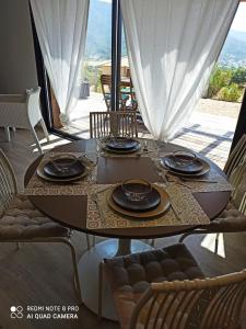 Vico的住宿－Sagone，一张木桌,上面有盘子和玻璃杯