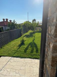 a shadow of a pole on a yard at Apartments Apartim Piran in Piran