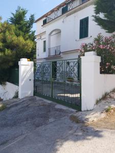 un cancello di fronte a una casa bianca di monolocale per le vacanze a Peschici