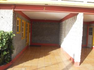 an empty room of a building with yellow doors at Hotel y Bungalows Monteverde in Chachalacas