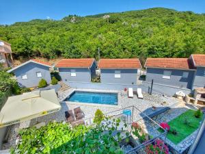 an aerial view of a house with a swimming pool at Studios Merdović in Budva