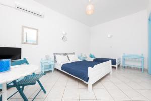 a bedroom with a bed and a table and a tv at Alekos Studios in Skala Potamias