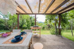 eine Terrasse mit einem Tisch und blauen Gerichten darauf in der Unterkunft #Pinetree Cabin by halu! Villas in Kalandra
